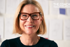 Happy coach with glasses on smiling at camera
