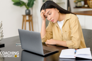 woman sat at desk looking at computer struggling to stay motivated
