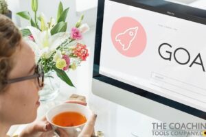Female Coach in front of computer setting up Goals Clinic