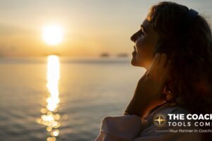 Woman on beach at sunrise with a gentle smile, symbolising reflection and mental well-being.